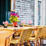 Outdoor cafe on a street of typical greek traditional village in Greece. Coffee on table for